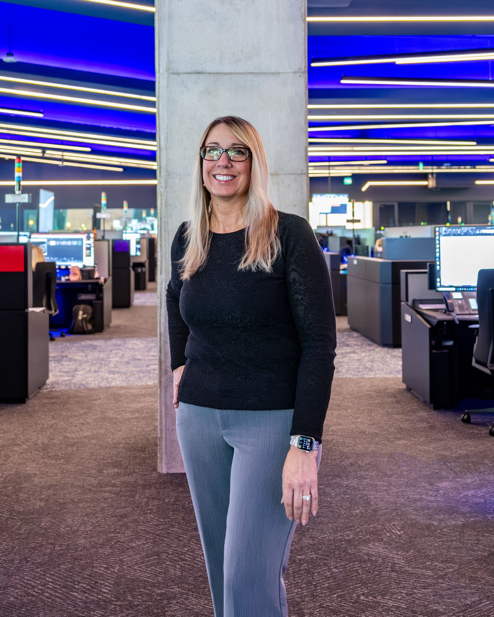 norfolk southern employee woman in operations in railway job standing proud in front of room of computers