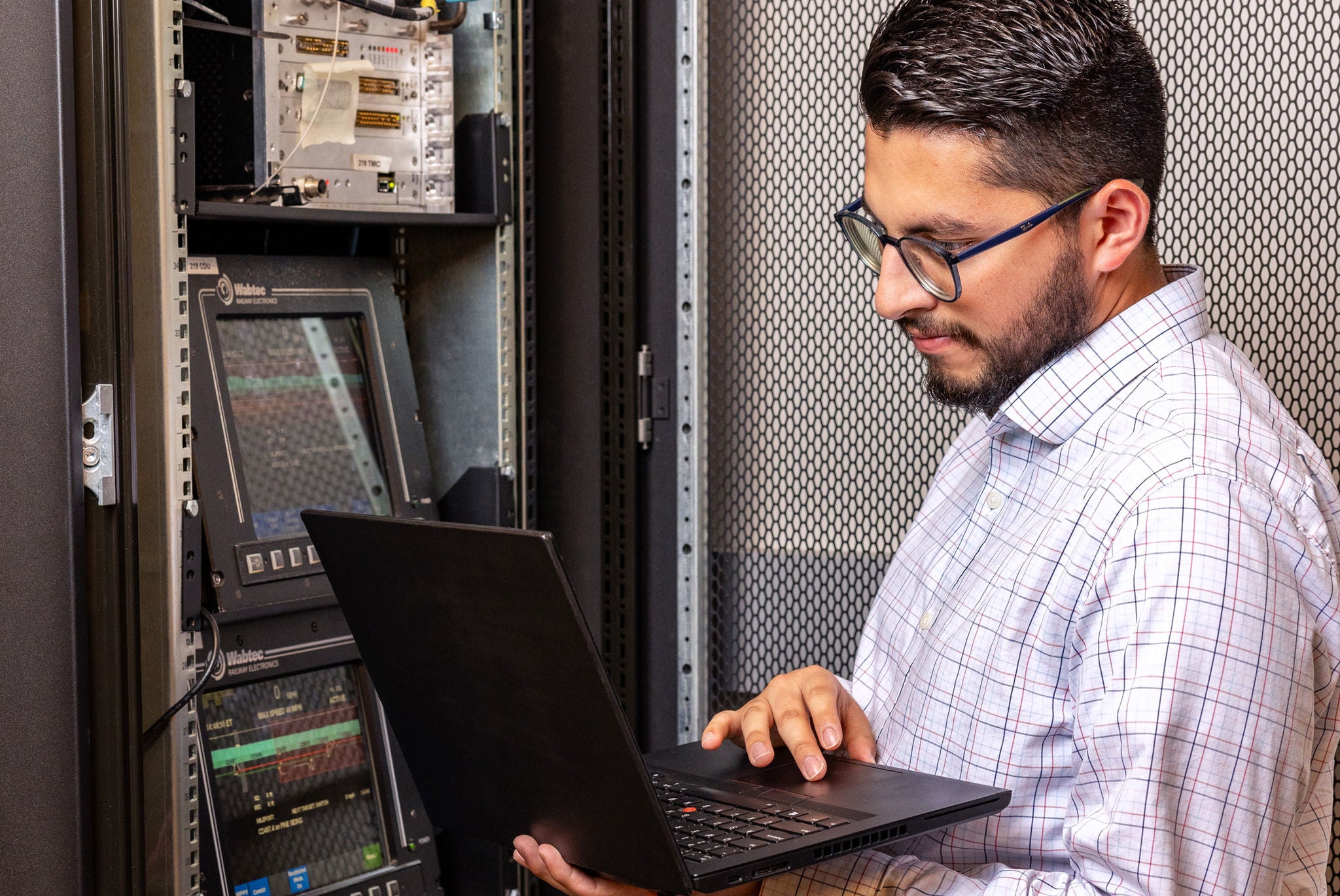 norfolk southern technology employee in railway job focused on technology on computer screen