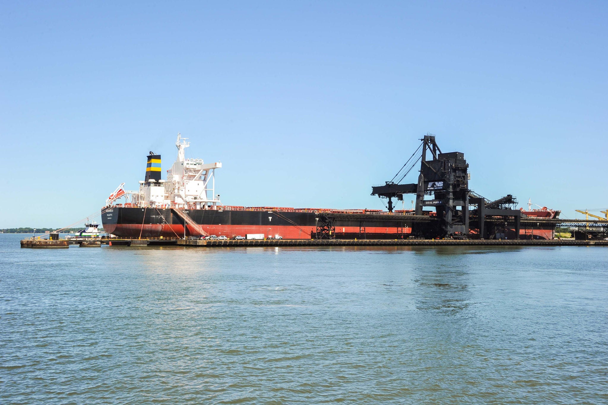 A coal shipping vessel stationed at a Norfolk Southern intermodal transportation port.