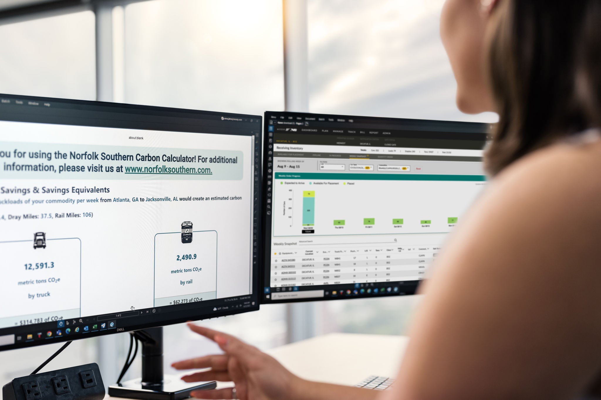 Working At a Computer To Calculate Carbon Savings Shipping Agricultural Products