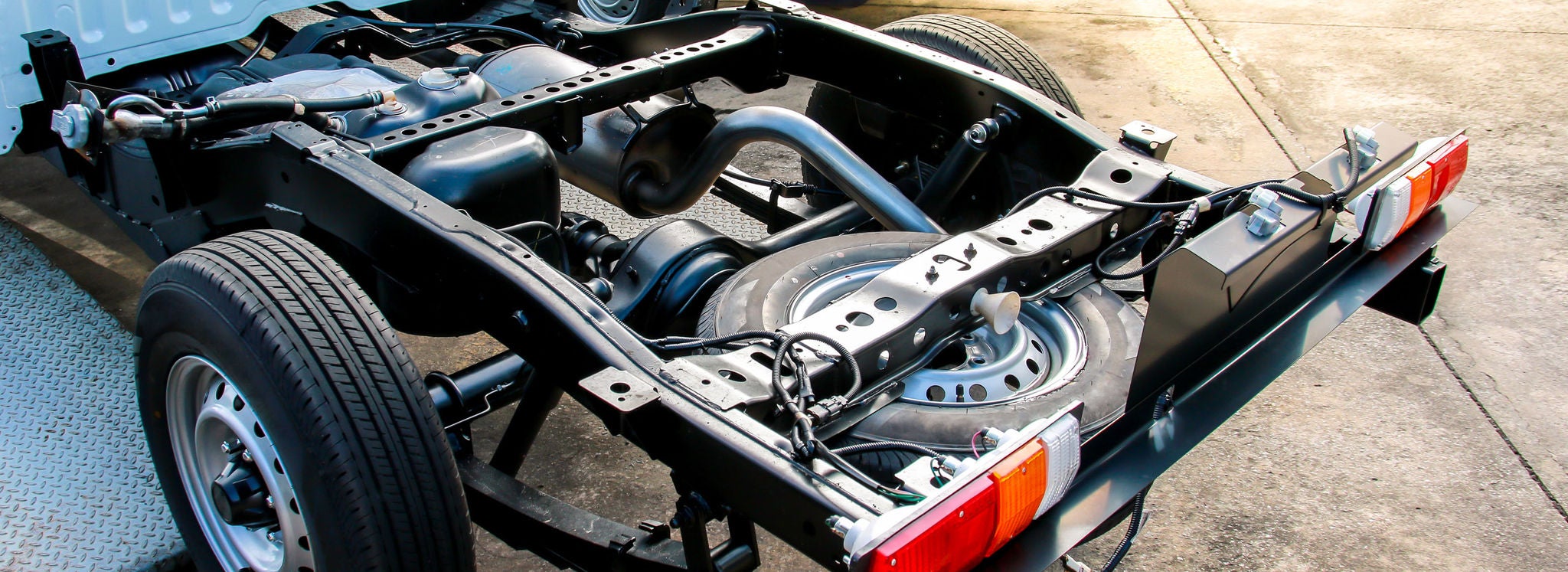 A closeup shot of automotive parts ready to be transported on an automobile transport rail.